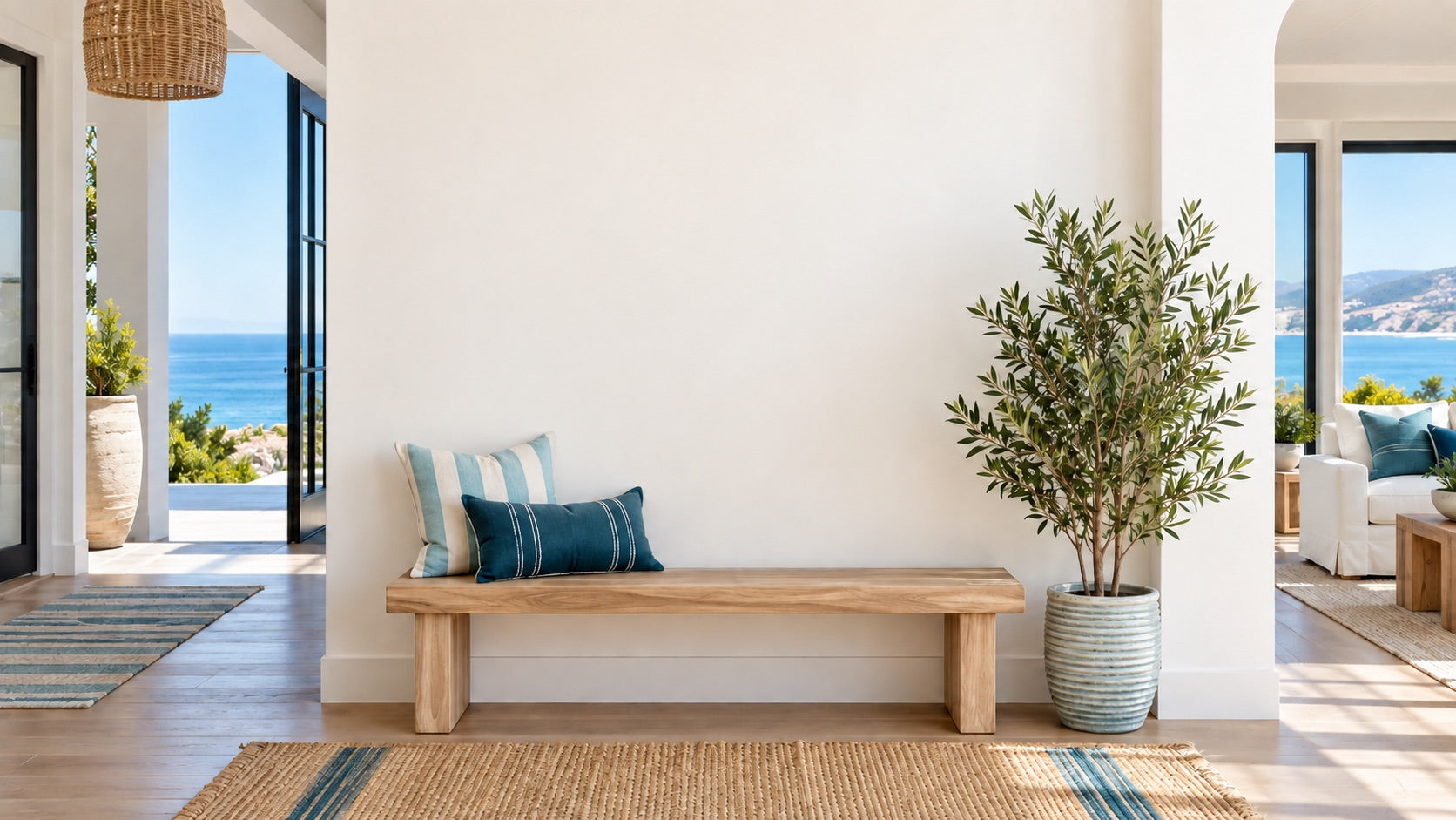 Bright coastal entryway with a bench and clear wall
